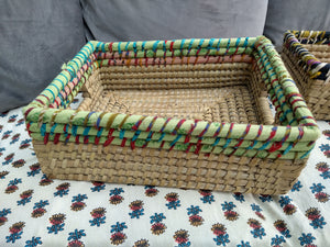 Natural hand woven basket with recycled fabric trim