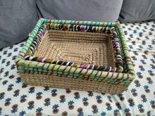 Natural hand woven basket with recycled fabric trim